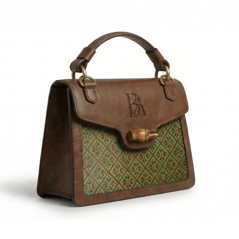 Heritage Arc bamboo leather handbag three-quarter view highlighting woven bamboo panel and leather structure