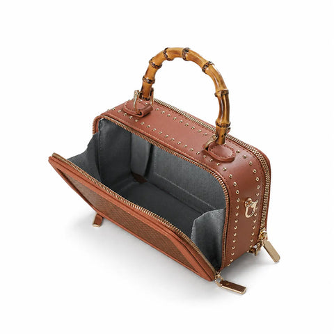 Open view of the Regent Weave bamboo box bag showing its structured interior and bamboo handle