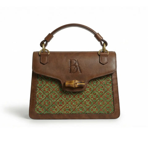 Heritage Arc bamboo leather handbag front view on neutral background showing structured silhouette