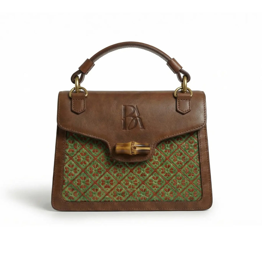 Heritage Arc bamboo leather handbag front view on neutral background showing structured silhouette