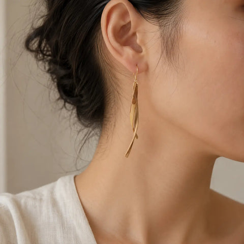 Close-up of Bamboura Wind Chimes lightweight bamboo earrings worn on ear