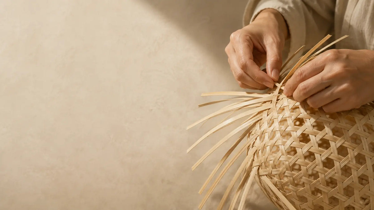 Close-up of handwoven bamboo strips being woven by hand, showing the texture and structure of traditional bamboo craft.