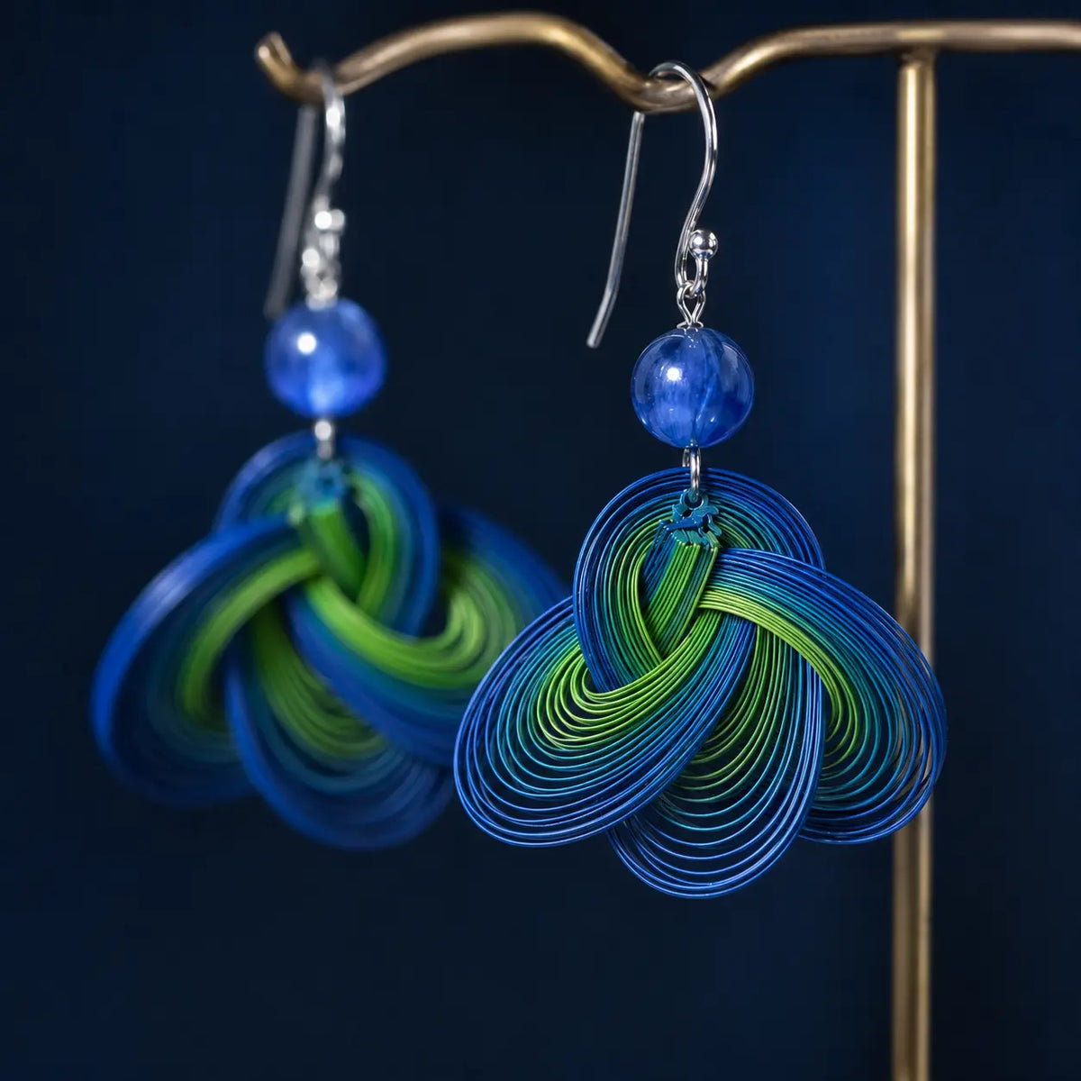 Close-up of handwoven bamboo and blue kyanite on Ocean Whispers earrings