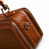 Side detail of the Regent Weave bamboo handbag with leather trim, metal studs and gold hardware