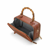 Open view of the Regent Weave bamboo box bag showing its structured interior and bamboo handle