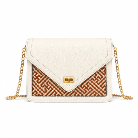 Bamboura Ivory Atelier ivory leather crossbody handbag with gold chain strap and woven bamboo front panel, designed for timeless everyday elegance.