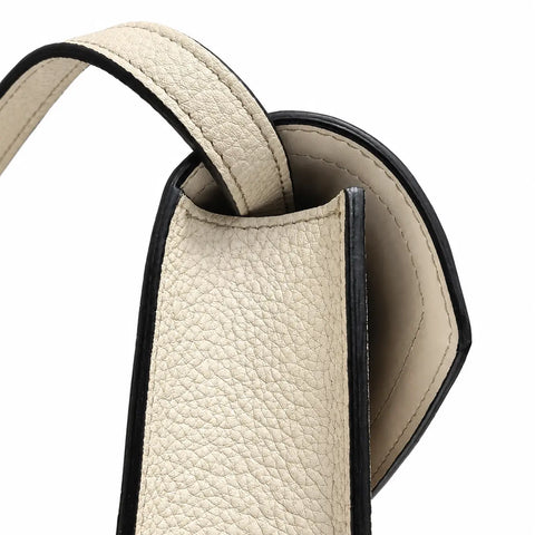 Side profile of Ivory Atelier luxury crossbody bag showing structured ivory leather construction, refined edges and handcrafted handbag design.