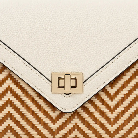 Close-up detail of Ivory Atelier bamboo leather handbag featuring premium ivory leather texture, gold clasp and intricate handwoven bamboo pattern.